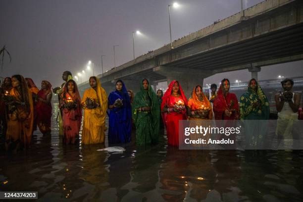 Hindu devotees perform rituals to the Sun god in the river Yamuna during Chhath Parva Festival in Noida the outskirts of New Delhi, India, October...