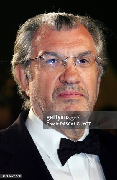 French journalist Serge July poses upon leaving the Festival Palace following the premiere of French director Rachid Bouchareb's film 'Indigenes' at...