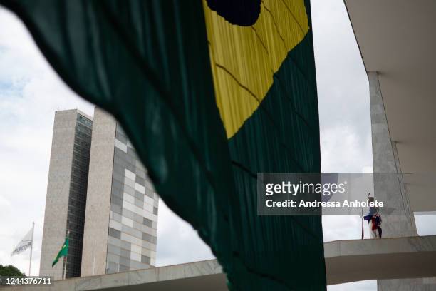 Guards stand next to a Brazilian flag at the Planalto Palace entrance the day after Lula da Silva defeated incumbent Jair Bolsonaro in the...