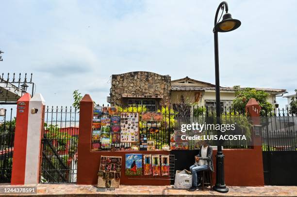 Painter sells his paintings on a street at Santa Ana Hill in the port city of Guayaquil, Ecuador, on October 30, 2022.