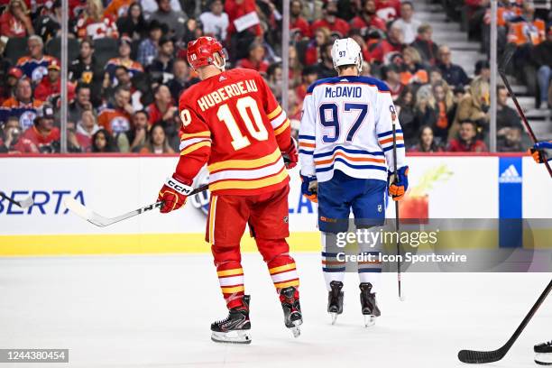 Calgary Flames Left Wing Jonathan Huberdeau and Edmonton Oilers Center Connor McDavid skate before a face-off during the third period of an NHL game...
