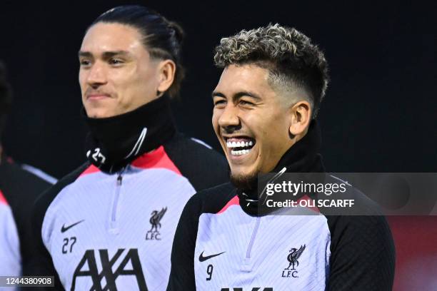 Liverpool's Brazilian striker Roberto Firmino and Liverpool's Uruguayan striker Darwin Nunez smile during a team training session at the AXA Training...