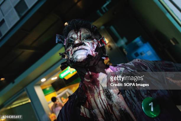 Person seen wearing make-up and dressed in a costume as a zombie during the Halloween parade Khaosan road one of the most famous walking street in...