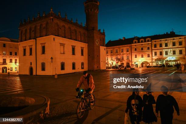 People walk on a pedestrian street with street lamps at the old town on October 31, 2022 in Tarnow, Poland. With winter arriving in the following...