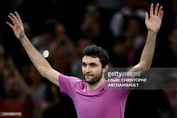 France's Gilles Simon celebrates after winning at the end of the men's singles match between Britain's Andy Murray and France's Gilles Simon on day...
