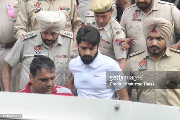 Gangster Lawrence Bishnoi amid heavy police security while coming out of the Amritsar court complex on October 31, 2022 in Amritsar, India. Gangster...