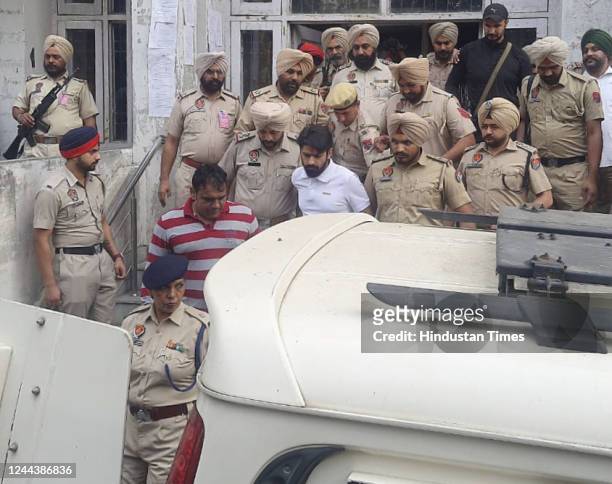 Gangster Lawrence Bishnoi amid heavy police security while coming out of the Amritsar court complex on October 31, 2022 in Amritsar, India. Gangster...