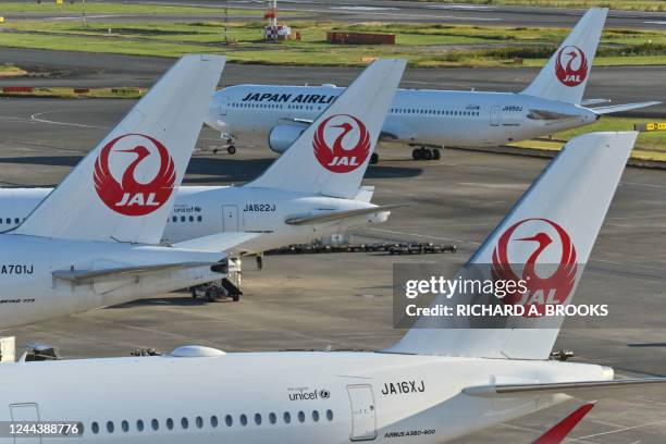 This photo taken on October 31, 2022 shows passenger planes for Japan Airlines on the tarmac at Tokyo International Airport at Haneda in Tokyo. - The...