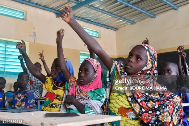 Pupils attend a lesson in a school created near a site for displaced people on the outskirts of Ouallam, Niger, on October 26, 2022. In Niger, 817...