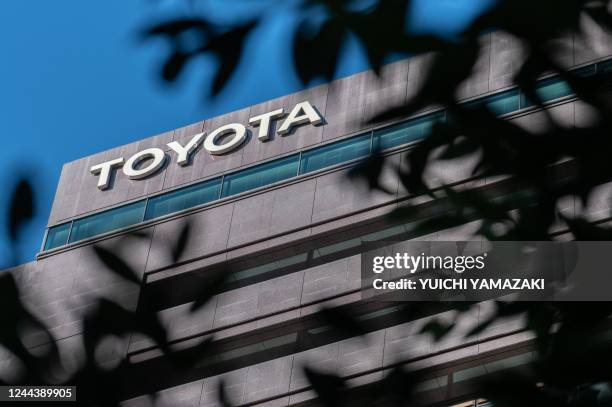 This picture taken on October 31, 2022 shows the logo of Toyota Motor being displayed atop the company's head office in Tokyo. - Toyota will release...