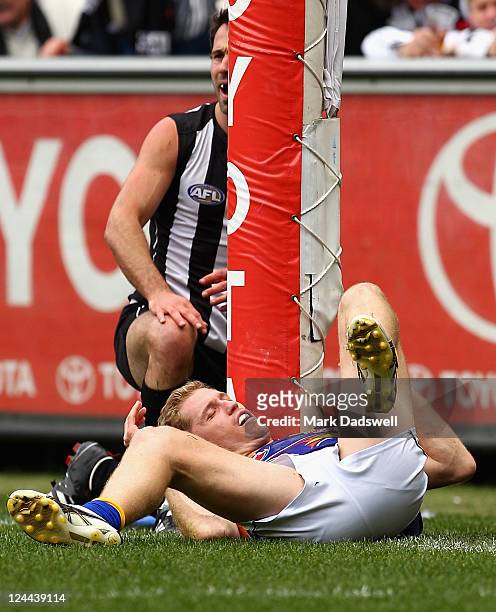 Alan Didak of the Magpies and Adam Selwood of the Eagles collide with a goal post during the AFL First Qualifying match between the Collingwood...
