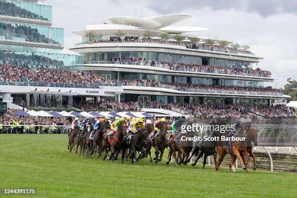 Horses round the first turn during the running of the Lexus Melbourne Cup at Flemington Racecourse on November 01, 2022 in Flemington, Australia.