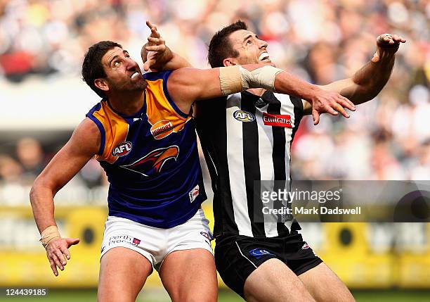 Dean Cox of the Eagles contests a boundary throw in with Darren Jolly of the Magpies during the AFL First Qualifying match between the Collingwood...