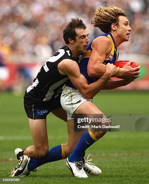 Steele Sidebottom of the Magpies tackles Matt Priddis of the Eagles during the AFL First Qualifying match between the Collingwood Magpies and the...