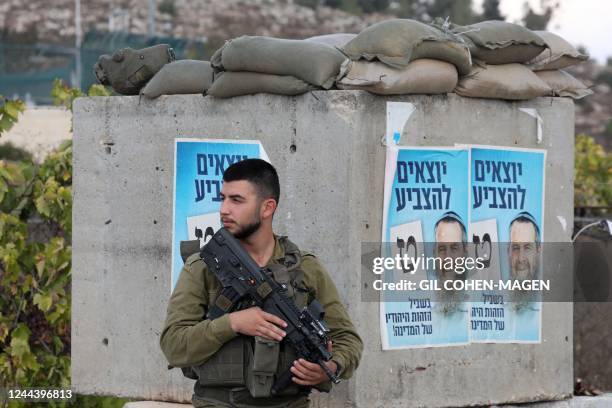An Iaraeli soldier is deployed at a position near Kiryat Arba in the occupied West Bank on the outskirts of Hebron on November 1 as Israelis began...