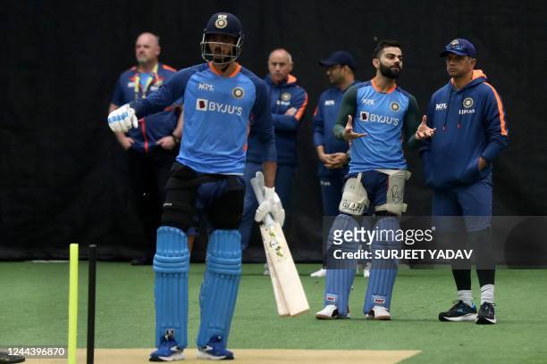India's Virat Kohli talks to team coach Rahul Dravid during net practice session ahead of the ICC men's Twenty20 World Cup 2022 cricket match India...