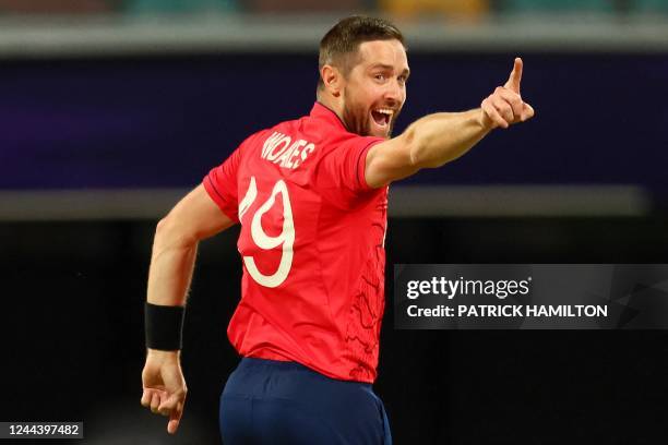 England's Chris Woakes celebrates the wicket of New Zealand's Devon Conway during the ICC men's Twenty20 World Cup 2022 cricket match between England...