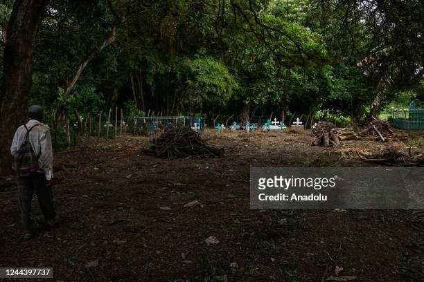 Salvadoran works cleaning the graves of his relatives buried in the backyard of their house, within the framework of the Day of the Dead, in the...
