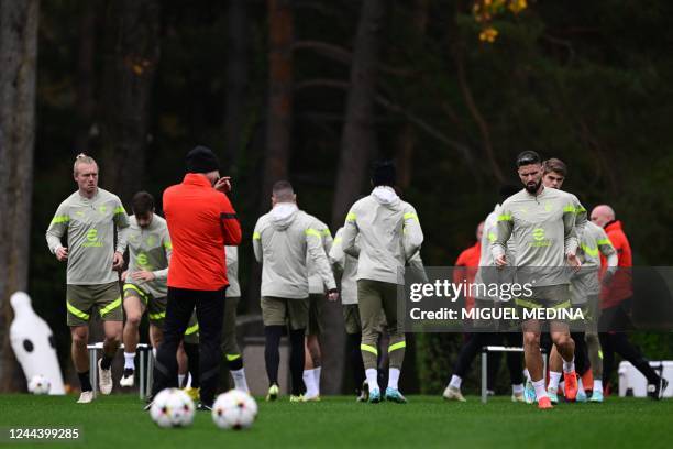 Milan's Danish defender Simon Kjaer and AC Milan's French forward Olivier Giroud attend a team training session at the Milanello sports center in...