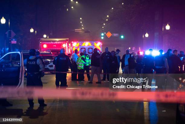 Chicago police and emergency medical responders gather at the scene of a mass shooting on Chicago&apos;s West Side near Polk Street and California...