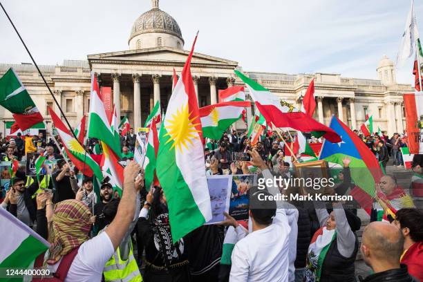 Demonstrators wave Iranian and Kurdistan flags in Trafalgar Square before forming a human chain in solidarity with protesters across Iran on 29...