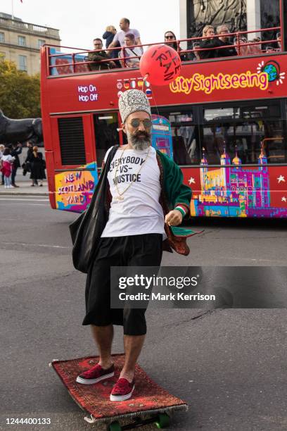 Demonstrator rides a skateboard covered in a carpet round Trafalgar Square during a human chain protest in solidarity with protesters across Iran on...