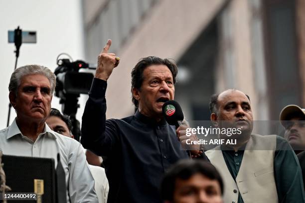 Pakistan's former prime minister Imran Khan addresses his supporters during an anti-government march towards capital Islamabad, demanding early...