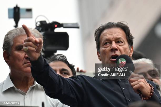 Pakistan's former prime minister Imran Khan addresses his supporters during an anti-government march towards capital Islamabad, demanding early...