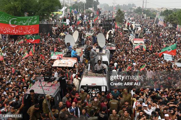 Supporters of Pakistan's former prime minister Imran Khan take part of an anti-government march towards capital Islamabad, demanding early elections,...