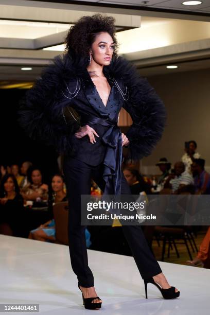 Model walks the runway wearing Gustavo Apit at the BAAADU Fashion And Awards Gala at Sonesta Los Angeles Airport LAX Hotel on October 30, 2022 in Los...