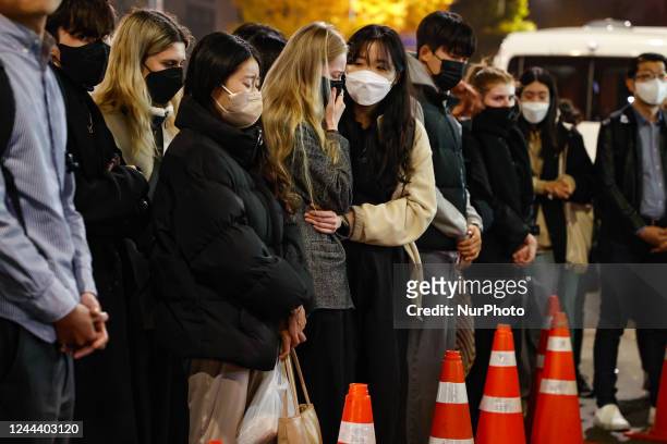 People cry during tribute for the victims of the Halloween disasters in Itaewon on November 01, 2022 in Seoul, South Korea. According to the National...