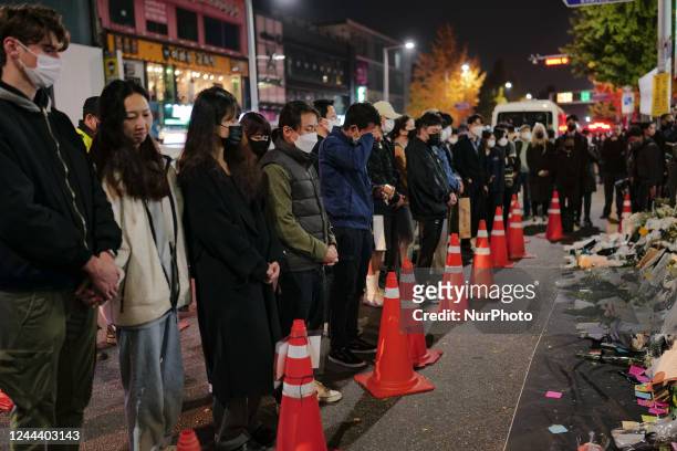 People pay tribute to the victims of the Halloween celebration stampede, on the Itaewon street near to the scene on November 01, 2022 in Seoul, South...