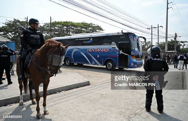 National Police forces escort a bus transferring inmates, outside the Litoral Penitentiary in Guayaquil, Ecuador, on November 1, 2022. - Two police...