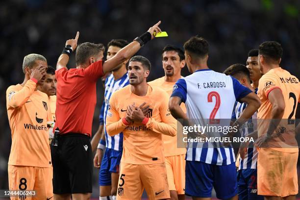 Atletico Madrid's Argentinian midfielder Rodrigo De Paul argues as he receives a yellow card from Italian referee Daniele Orsato during the UEFA...