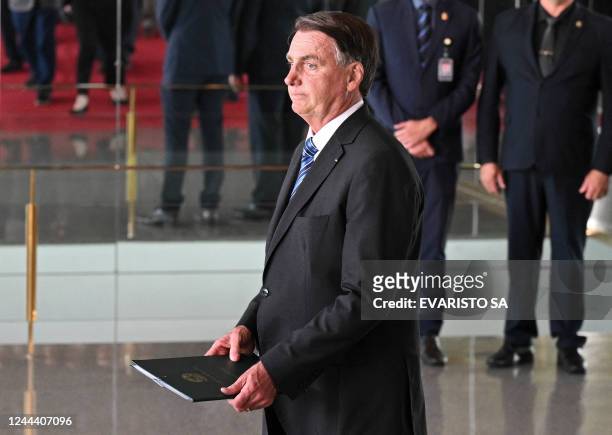 Brazilian President Jair Bolsonaro appears to make a statement for the first time since Sunday's presidential run-off election, at Alvorada Palace in...