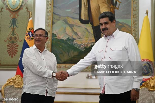 Colombian President Gustavo Petro and Venezuelan President Nicolas Maduro shake hands during a meeting at Miraflores Presidential Palace in Caracas,...