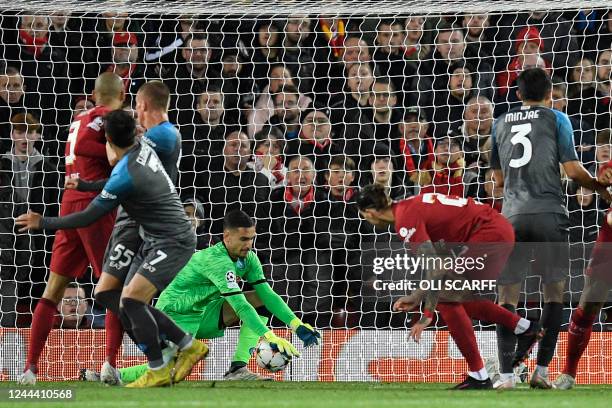 Napoli's Italian goalkeeper Alex Meret spills a header from Liverpool's Uruguayan striker Darwin Nunez before Liverpool's Egyptian striker Mohamed...