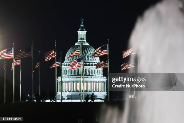 The Capitol building is seen through the American flags in Washington DC on October 20, 2022.