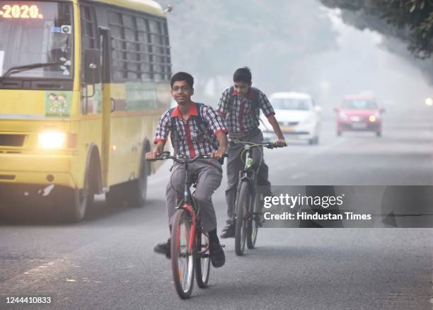 School children seen riding bicycles on a misty winter morning, at Dwarka on November 1, 2022 in New Delhi, India. The air quality in Delhi continued...