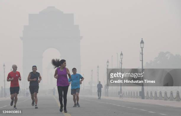 Pedestrians at India Gate on a misty morning on November 1, 2022 in New Delhi, India. The air quality in Delhi continued to remain in the very poor...