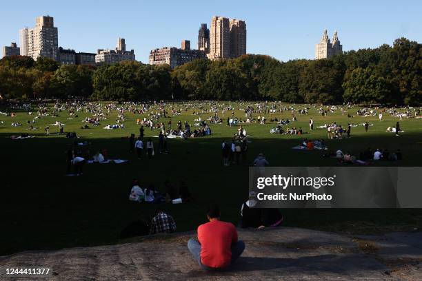 People rest on the Sheep Meadow in the Central Park in New York City, United States on October 22, 2022.