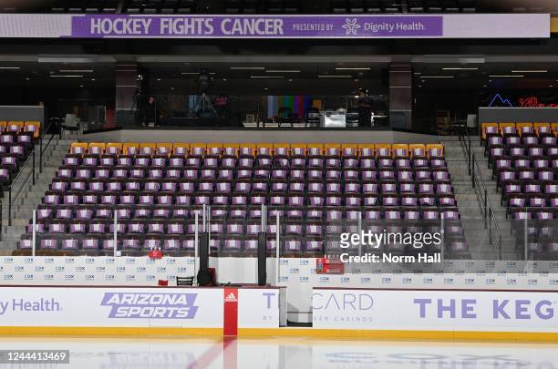 Signs for Hockey Fights Cancer night hang on the backs of the seats at Mullett Arena prior to a game between the Arizona Coyotes and the Florida...