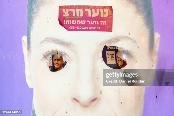 Stickers of the left-wing party Meretz and the right-wing Likud parties are stuck on a sign with a picture of Merav Michaeli, the leader of the...