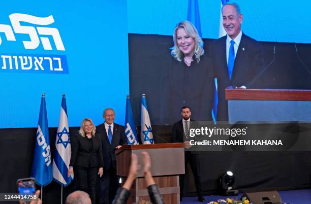 Israel's ex-premier and leader of the Likud party Benjamin Netanyahu, flanked by his wife Sara, addresses supporters at campaign headquarters in...