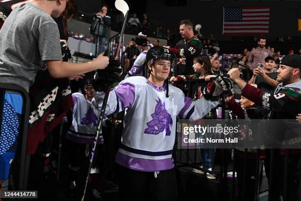 Barrett Hayton of the Arizona Coyotes prepares to take the ice on Hockey Fights Cancer Night before a game against the Florida Panthers at Mullett...