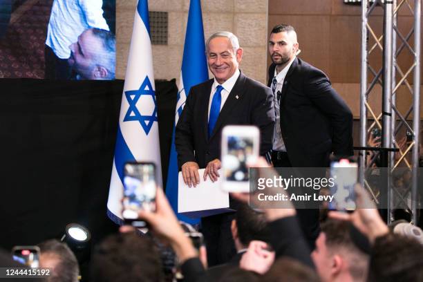 Former Israeli Prime Minister and Likud party leader Benjamin Netanyahu smiles as he enters an election night event for the Likud party on November...