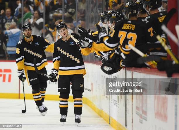 Josh Archibald of the Pittsburgh Penguins celebrates with teammates on the bench after scoring a goal in the second period during the game against...