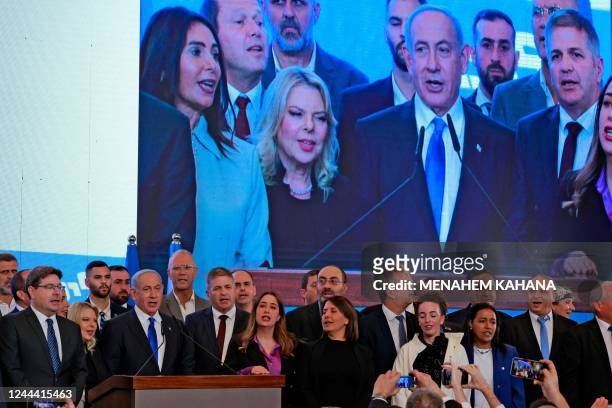 Israel's ex-premier and leader of the Likud party Benjamin Netanyahu and party members sing the national anthem as they address supporters at...