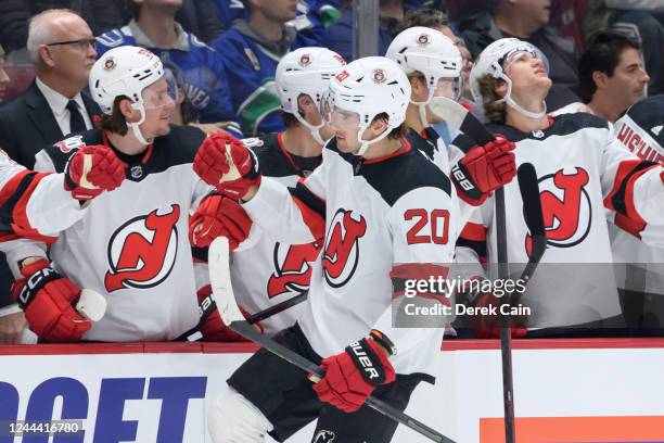 Michael McLeod of the New Jersey Devils is congratulated at the player's bench after scoring a goal against the Vancouver Canucks during the first...