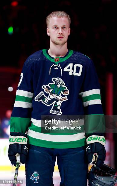 Elias Pettersson of the Vancouver Canucks stands for the national anthem before their NHL game against the New Jersey Devils at Rogers Arena November...